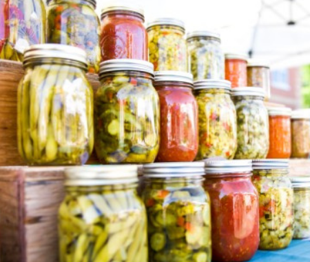 Three rows of jars with various vegetables preserved